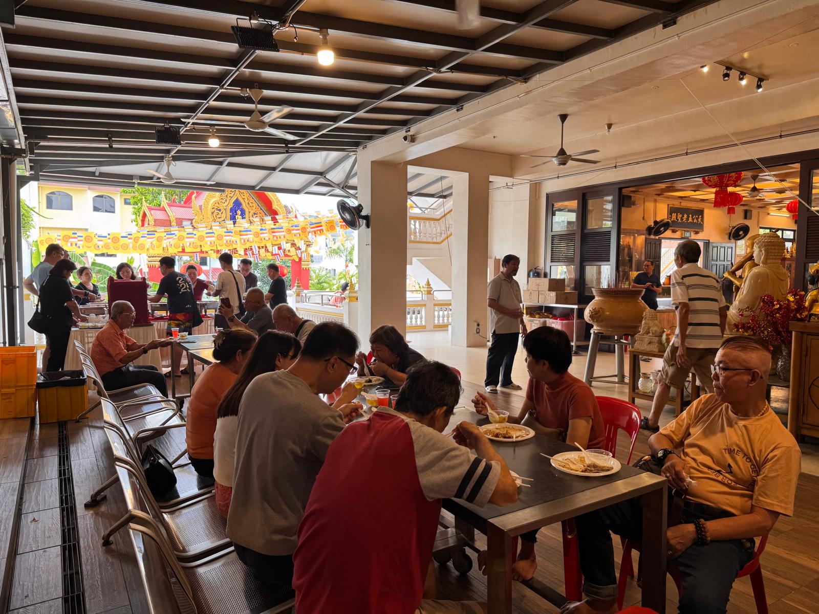 Temple community sharing a meal after monthly chanting